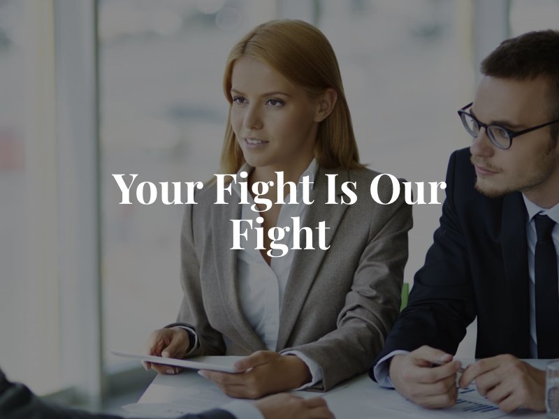 Two personal injury attorneys in Seattle talking to a client with the text overlay 'Your Fight is Our Fight'