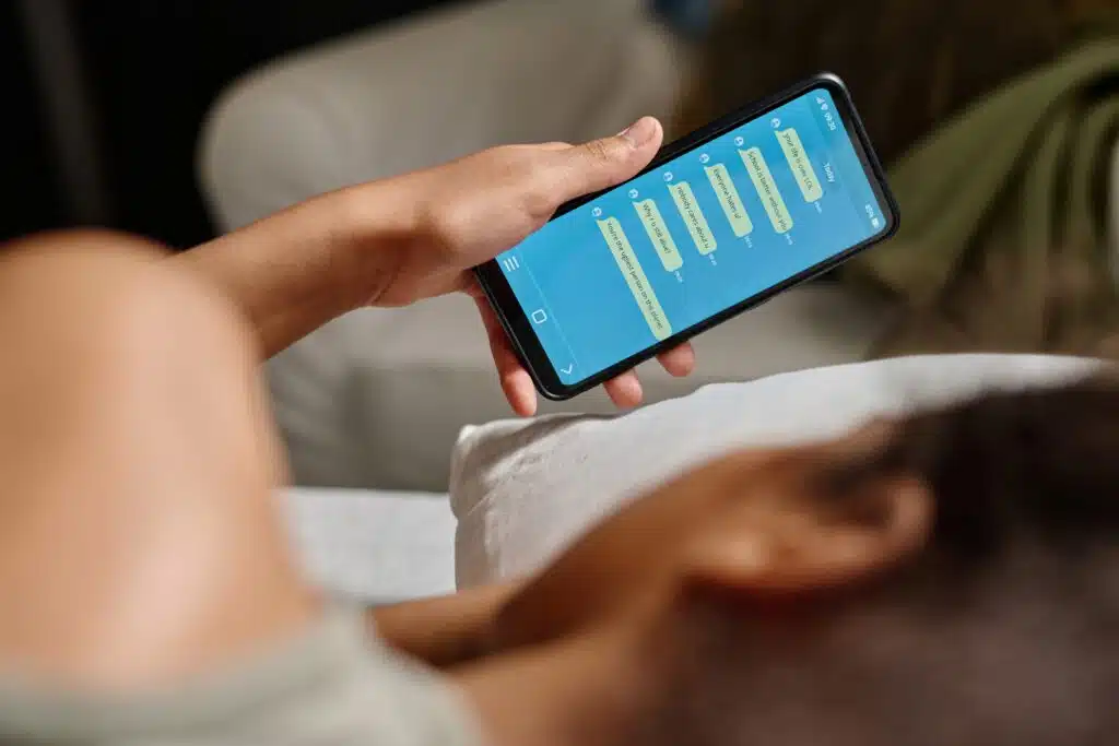 Teen looking at phone messages from cyberbully